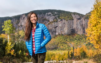 Woman in a fashionable insulated jacket in the fall nature