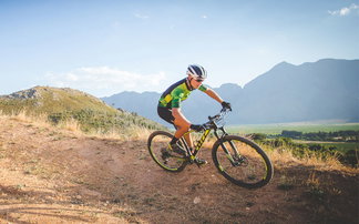 Mountain bike hardtail rider on a sunny trail
