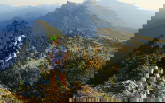 Trail runner in the mountains in front of mountain scenery